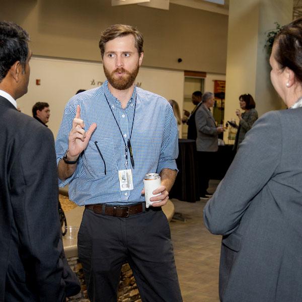 coles marketing and sales students in conversation at conference